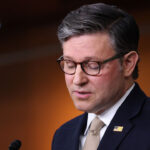 Mike Johnson speaks to reporters at a capitol press conference.