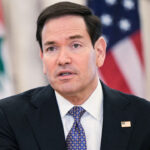Marco Rubio speaks to reporters at a summit.