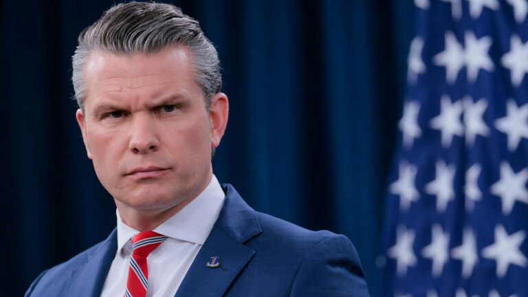 Close-up of Secretary of War Pete Hegseth as he speaks to reporters.