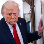President Donald Trump speaks to reporters on Air Force One.