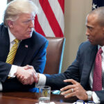 Donald Trump shaking the hand of Department of Housing and Urban Development Secretary Scott Turner. Turner condemned "fraud" in Los Angeles housing.