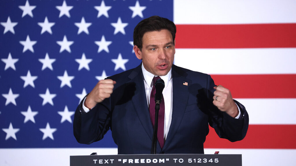 Ron DeSantis speaks in front of an American flag