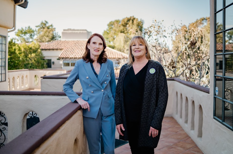 Teachers Sue Gavin Newsom Over Policy Forcing Them to Lie About Student’s Transgender Status to Parents 1 Two women stand on a balcony outside.
