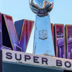 A large stand showing the words LVII and Super Bowl with the Lombardi Trophy.