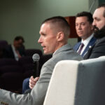 FBI agents Stephen Friend and Garret O'Boyle speak with Rep. Jason Chaffetz, wearing suits