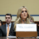 Riley Gaines sitting at a witness table testifying during a House committee hearing