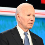 Joe Biden in a suit looks blankly in the debate