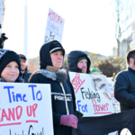 Fishermen and their families protest at the Supreme Court