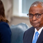 Defense Secretary Lloyd Austin looking at the camera.