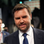 J.D. Vance in a suit looks at the camera