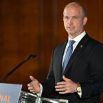 Heritage Foundation President Kevin Roberts giving a speech at a podium.