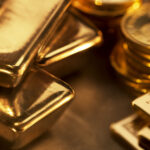 Close up image of assorted gold ingots and gold coins
