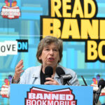 Randi Weingarten speaks in front of a background that says "Read Banned Books."