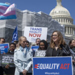 Sarah McBride in front of trans flag