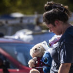 Dejected woman walks in the aftermath of Hurricane Helene