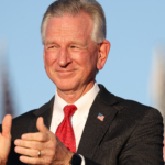 Sen. Tommy Tuberville, R-Ala., applauds at a campaign rally.