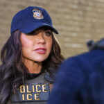 Department of Homeland Security Secretary Kristi Noem in a police/ICE vest and matching cap