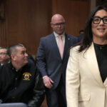Lori Chavez-Deremer enters the Senate committee hearing room accompanied by Teamsters President Sean O'Brien.