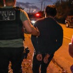 An ICE agent makes an arrest.
