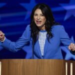 Dana Nessel is giving a speech and pointing her finger in an animated gesture.