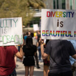 Students at the University of South Florida, Tampa hold signs such as "Diversity is Beautiful" to protest Gov. Ron DeSantis's crackdown on DEI at the state's colleges and universities.