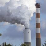 A smokestack from a coal-fired plant in Pennsylvania is seen through the trees.