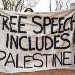 Demonstrators hold up a sign in favor of Palestine on the Harvard University campus.