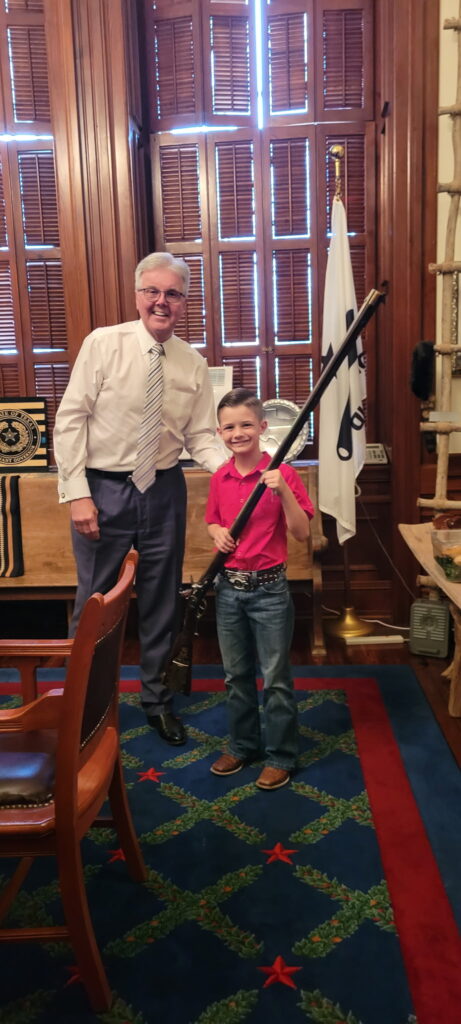 Wyatt Franklin poses in a picture with Lt. Gov. Dan Patrick holding a replica of a musket rifle used in the Battle of the Alamo

(Image courtesy of Candace Franklin)