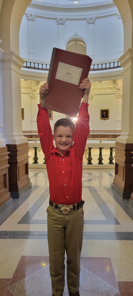 Wyatt Franklin holds Rep. Steve Toth's bill that was passed.

(Image courtesy of Candace Franklin)