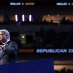Rep. Mike Collins is pictured in a suit and speaks at a podium during the Republican National Convention, with REPUBLICAN CONVENTION and 2028 visible on a screen in the background, and an audience in a darkened arena.