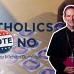 A Catholic bishop stands beside a table of I Voted stickers. Text reads: Catholics Vote No. Bishop Michael Burbidge..