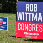 Political yard signs for Rob Wittman for Congress and Bert Mizusawa for U.S. Senate in a grassy yard.