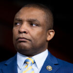 Portrait of Congressman Marc Veasey wearing a blue suit and yellow-and-blue striped tie.