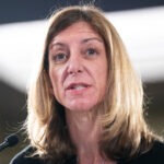 A woman speaking into a microphone.