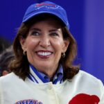Kathy Hochul wearing a Buffalo Bills cap and jacket.