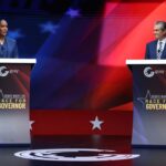 Keisha Lance Bottoms and Rick Jackson stand at separate podiums labeled Debate Night Live Race for Governor during a televised gubernatorial debate.