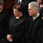 Four Supreme Court Justices in black robes seated together to deliberate on cases involving legal fines.