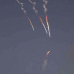 Iranian missiles streak against a dark sky.