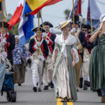 Daughters of the American Revolution and Sons of the American Revolution take part in a Fourth of July parade.