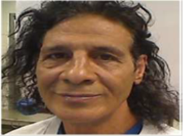 EXCLUSIVE: ICE Arrests 5 Criminal Illegal Aliens 2 A person with long, dark curly hair and a slight smile faces the camera. They are wearing a light-colored shirt and are indoors, with a blurred background.