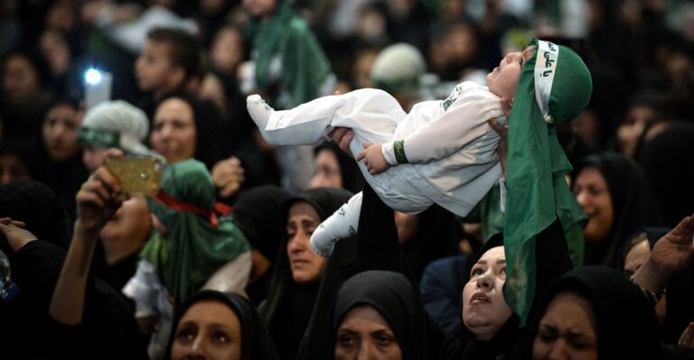 Symbolic Ritual in Iran Sees Women Hold Infants Aloft as Sacrifice