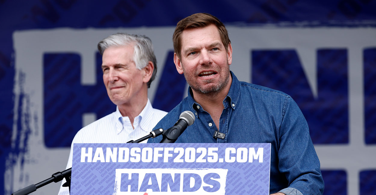 Eric Swalwell behind a podium reading "Handsoff2025.com"