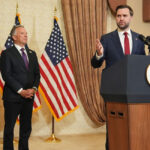 JD Vance speaks from a podium. Behind him are Steve Witkoff and Jared Kushner.