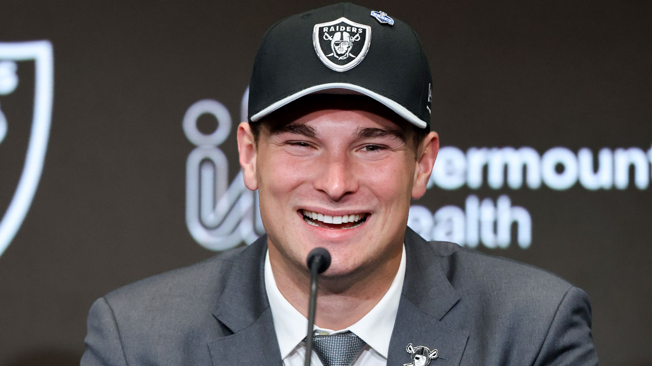 A close-up of a beaming Fernando Mendoza in a Las Vegas Raiders cap.