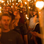 Young men, reported to be Neo Nazis, Alt-Right and other white supremacists, carry torches through University of Virginia campus.