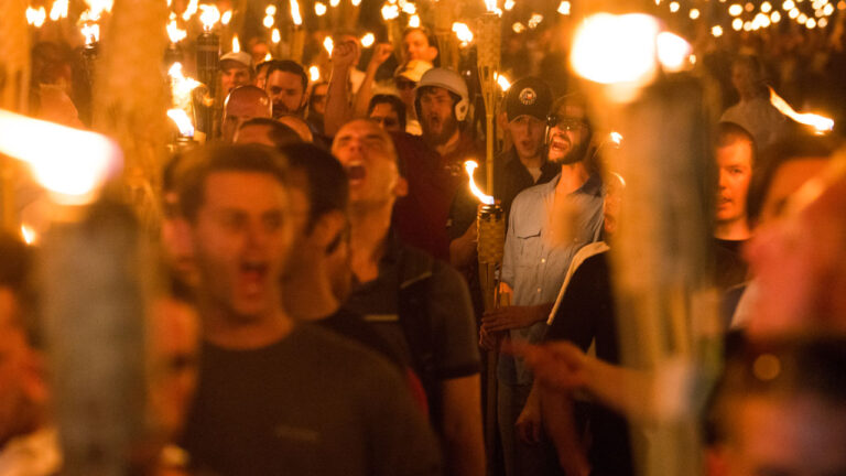 Young men, reported to be Neo Nazis, Alt-Right and other white supremacists, carry torches through University of Virginia campus.