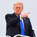 Donald Trump against light blue sky points.