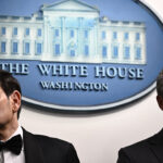 A stern looking Marco Rubio and Pete Hegseth stand together in White House briefing room.
