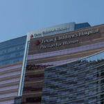 Low-angle shot of Texas Children's Hospital against a blue sky.