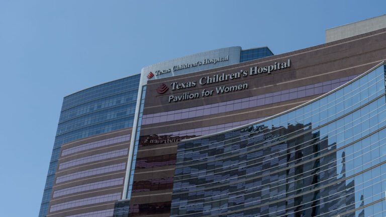 Low-angle shot of Texas Children's Hospital against a blue sky.